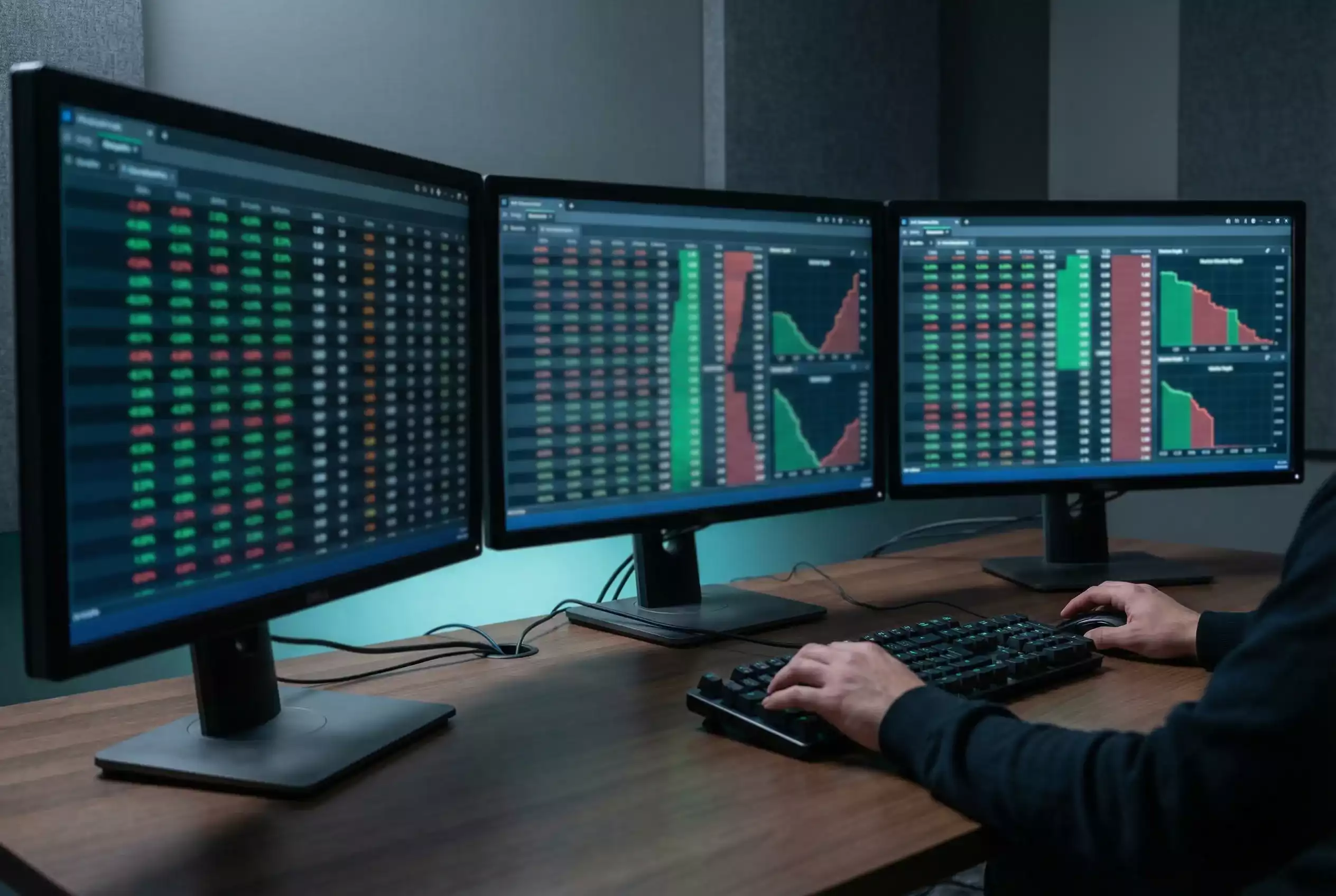 Multiple computer screens showing live horse racing odds and betting exchange data