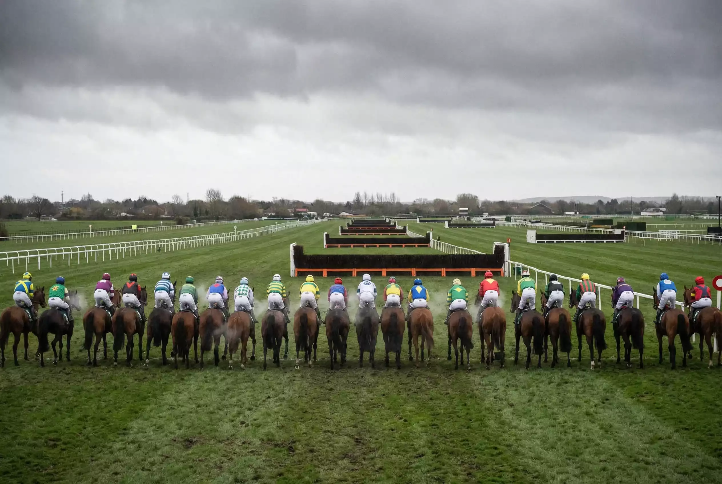 Horses lining up at starting stalls before Grand National with reserve runners waiting