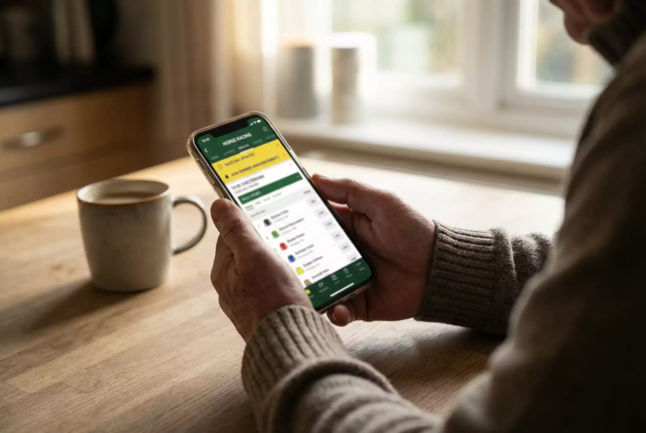 Punter checking racing app for non runner updates on smartphone